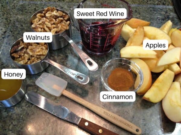 Ingredients for haroset including apples, wine, walnuts, honey, and cinnamon.