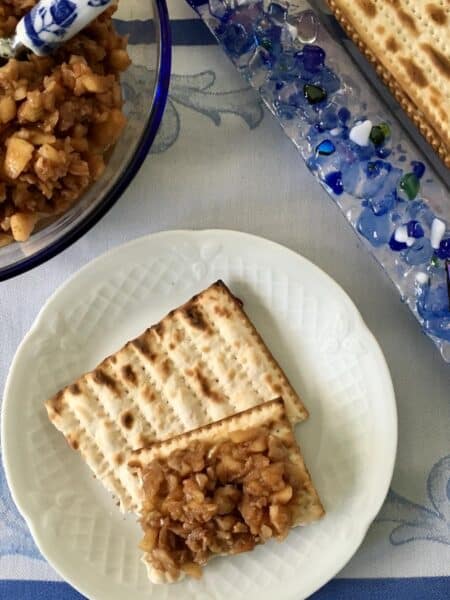 A piece of matzo topped with apple haroset for Passover