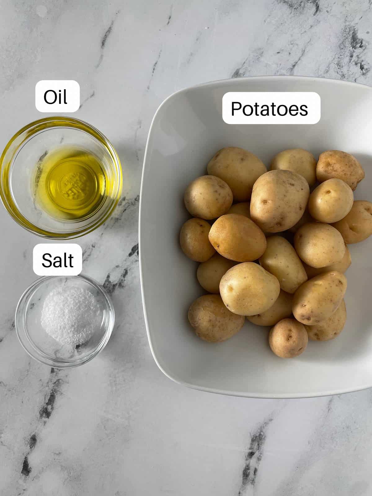 Potatoes, salt, and oil in bowls.