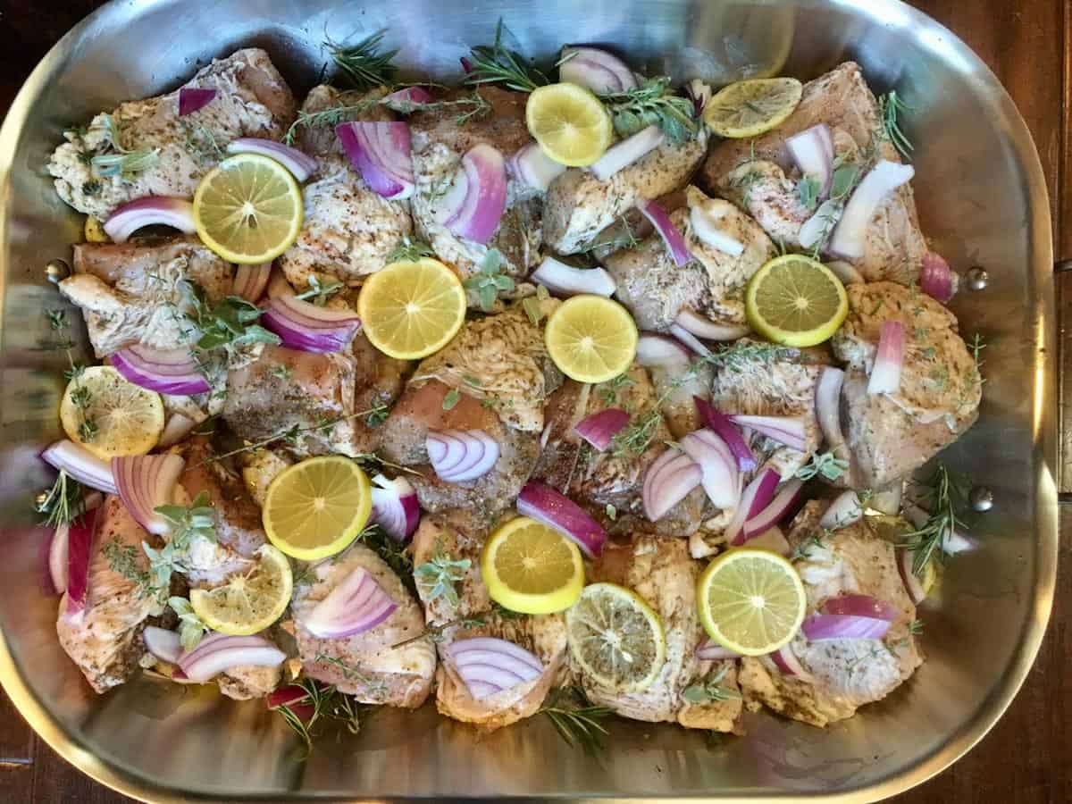 Za'atar lemon herbed chicken in pan ready for the oven.