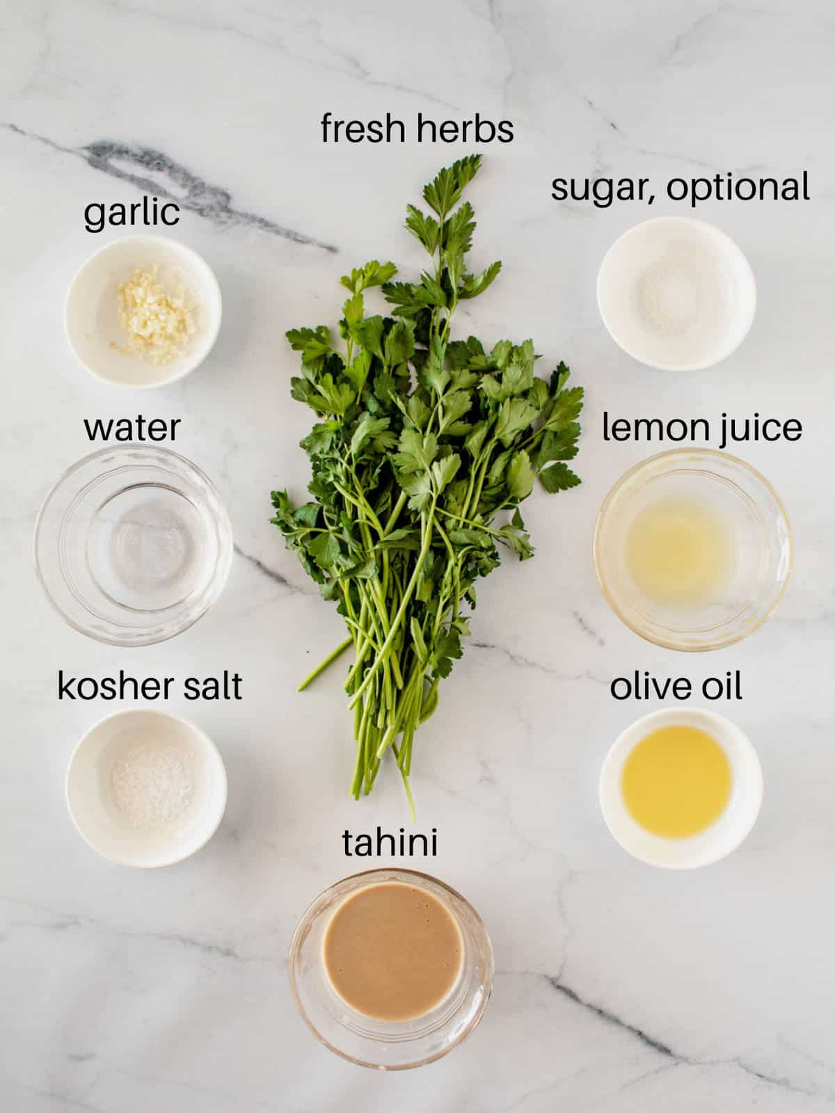 Ingredients needed for lemon herb green tahini sauce.