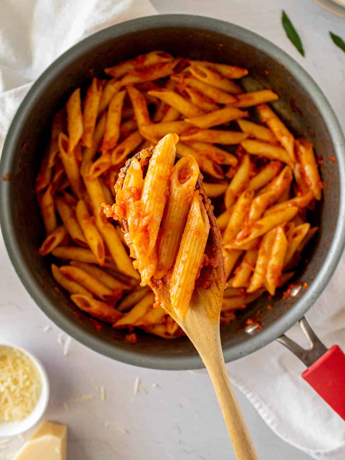 Tomato and veggie sauce with pasta in a pan.