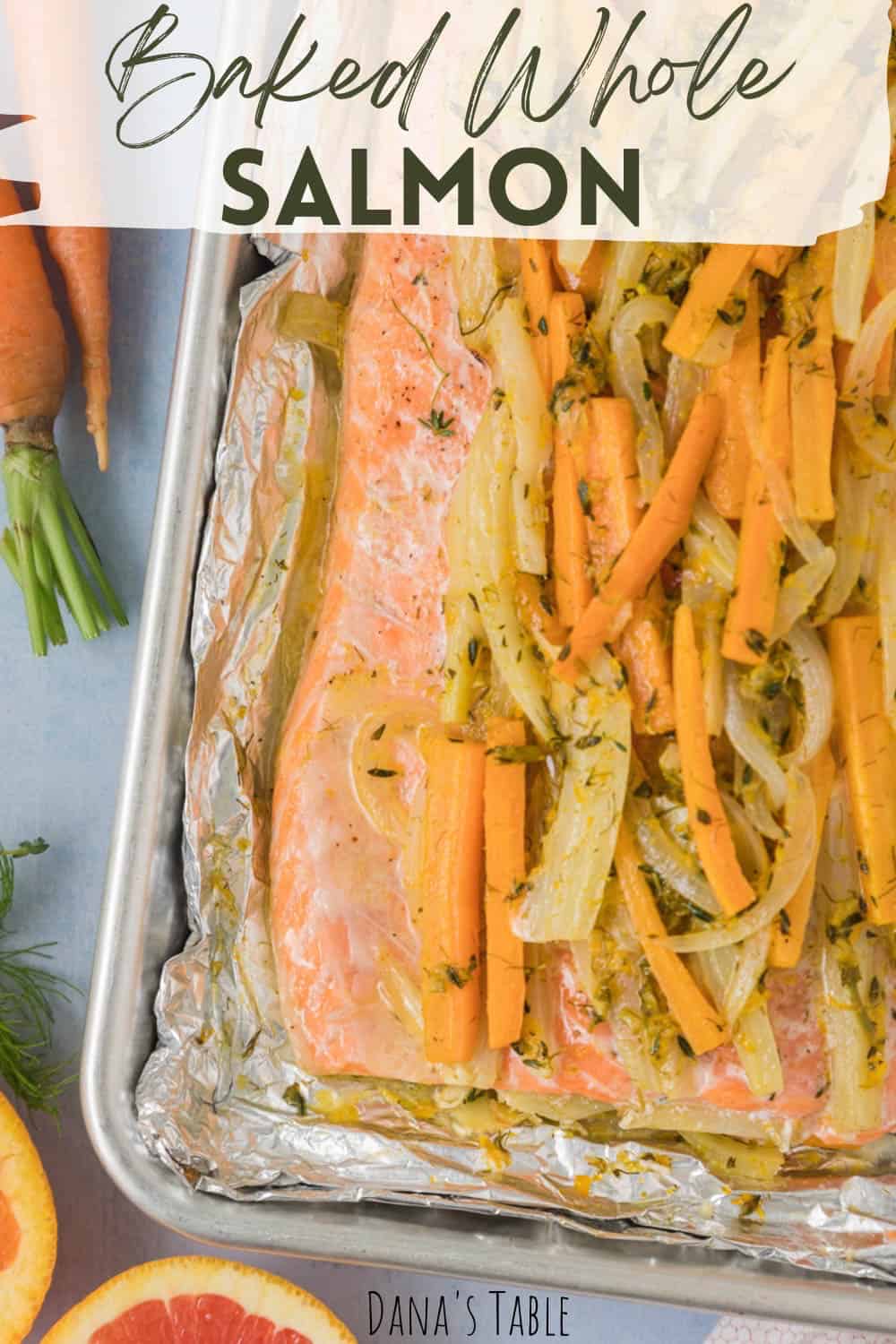 Salmon and vegetables on a baking sheet just out of the oven.