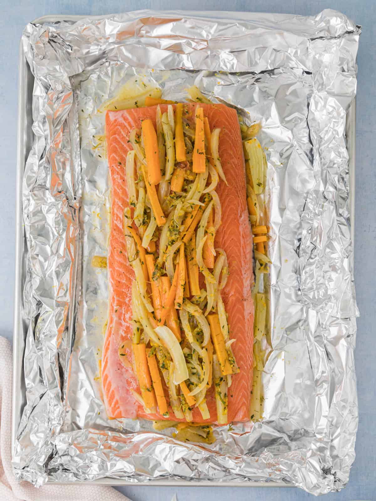 Salmon with fennel on a baking sheet and foil packet.