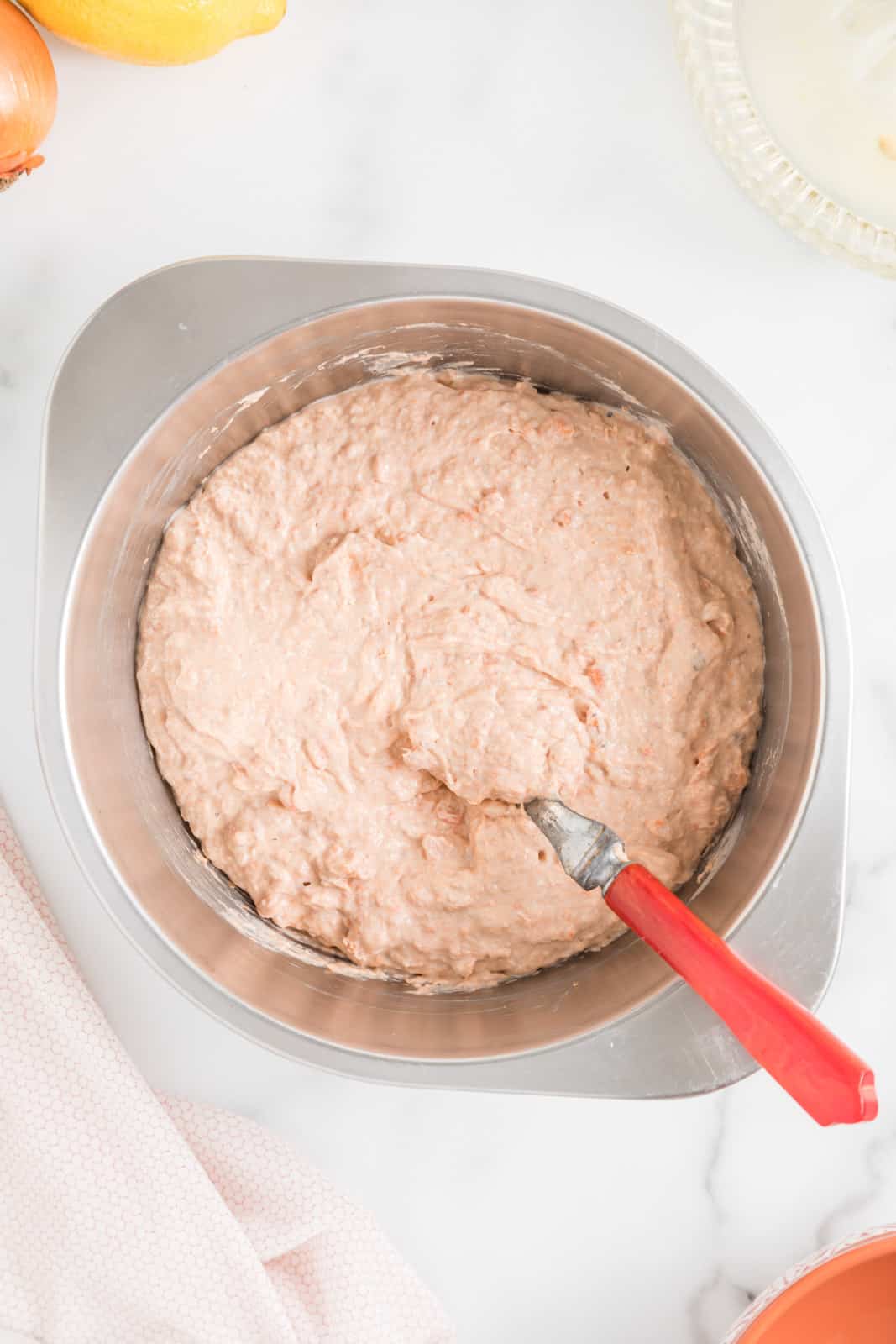 Salmon mousse ingredients just mixed in a metal bowl.