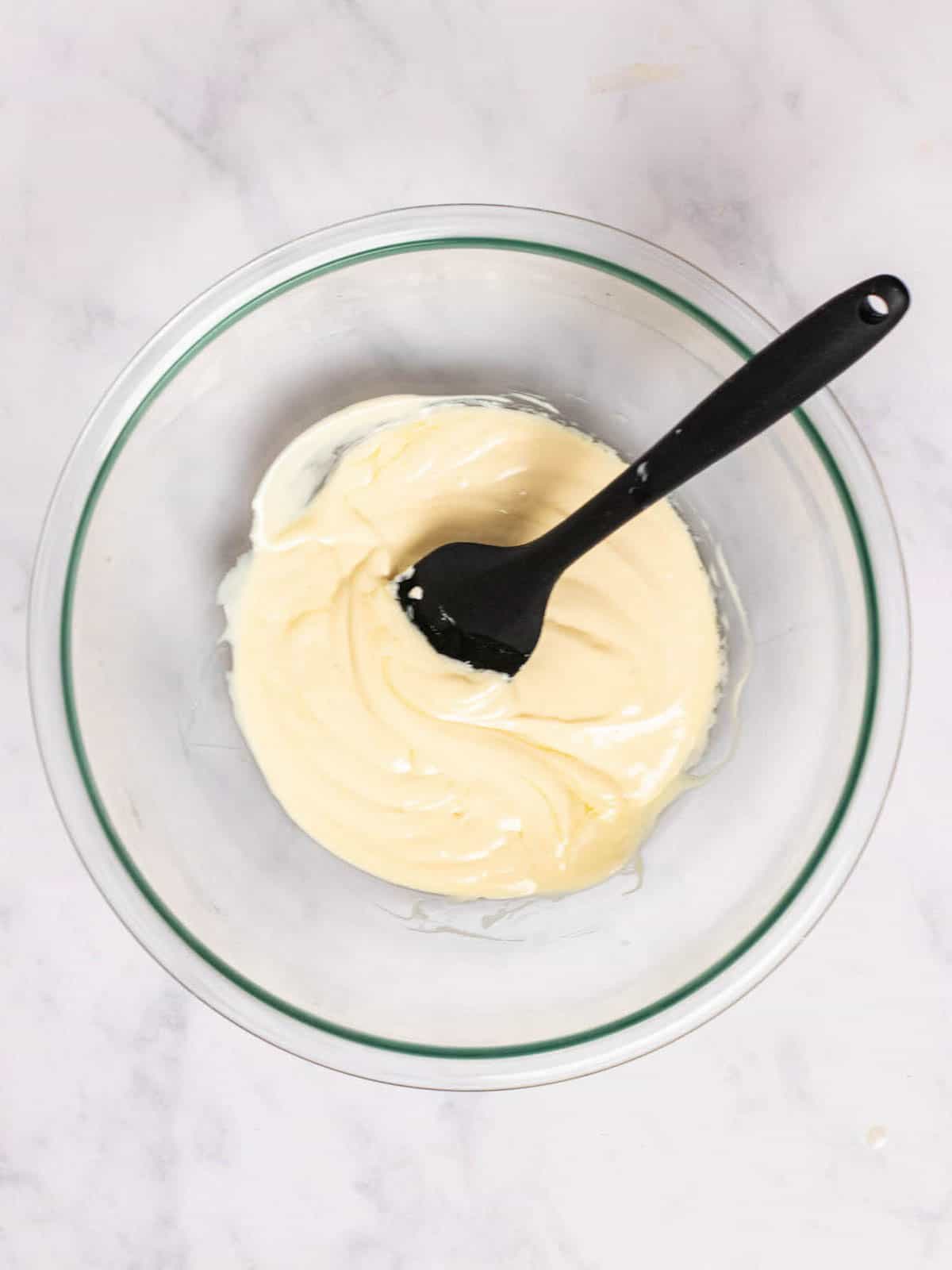 Soften cream cheese and cooled melted margarine combined in a glass bowl.