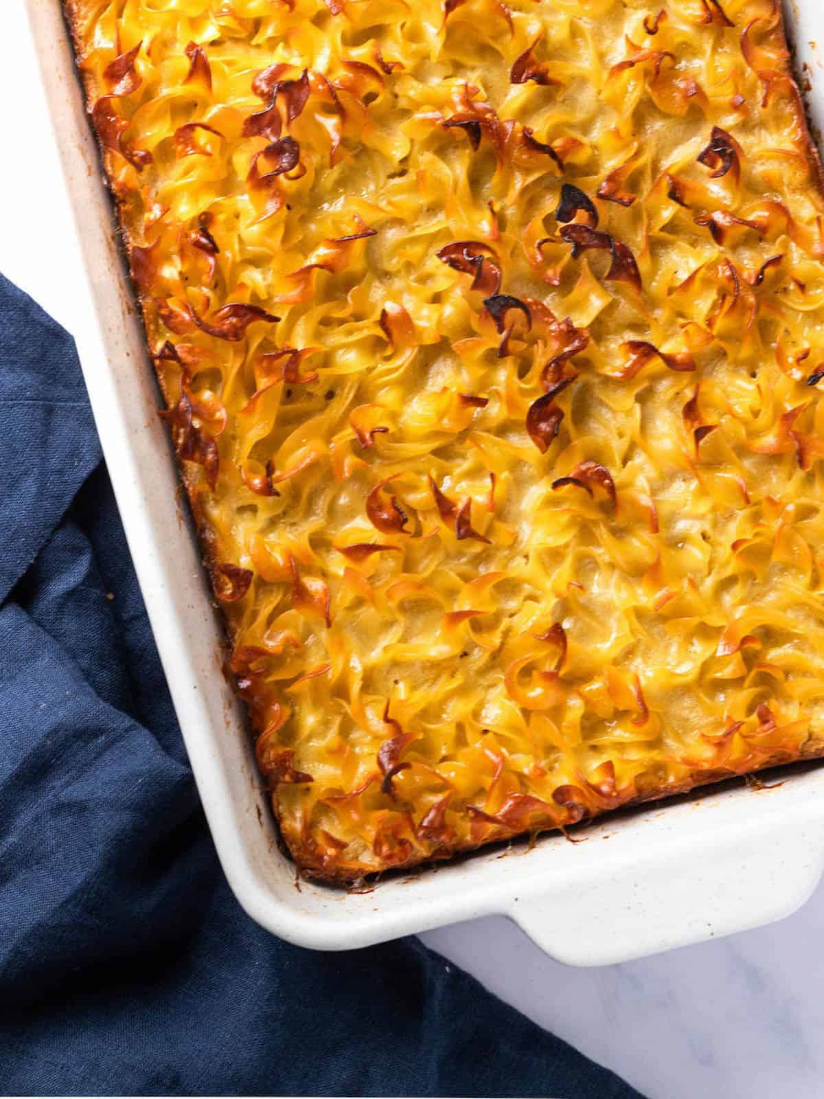 The noodle kugel is finished baking and has a crispy top.