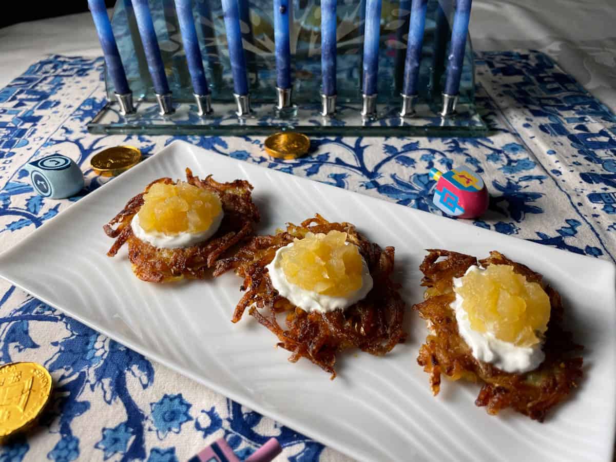 Applesauce on top of potato latkes for Hanukkah.