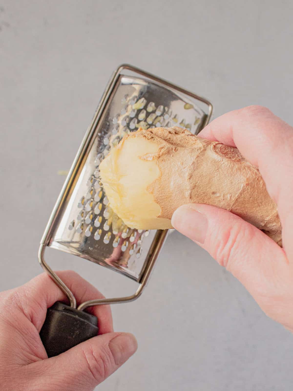 Grating ginger with a microplane.