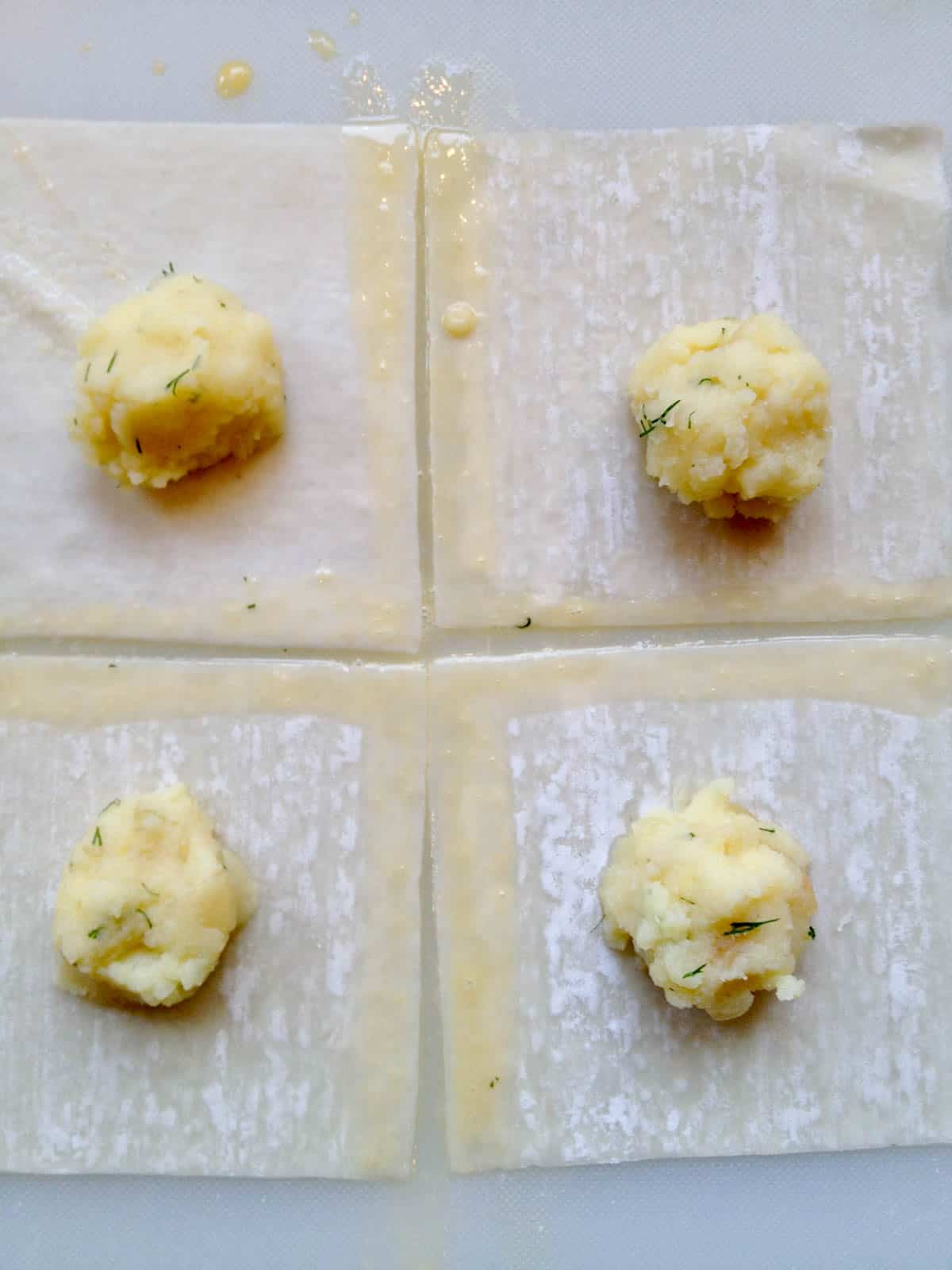 Wonton squares with potato filling.