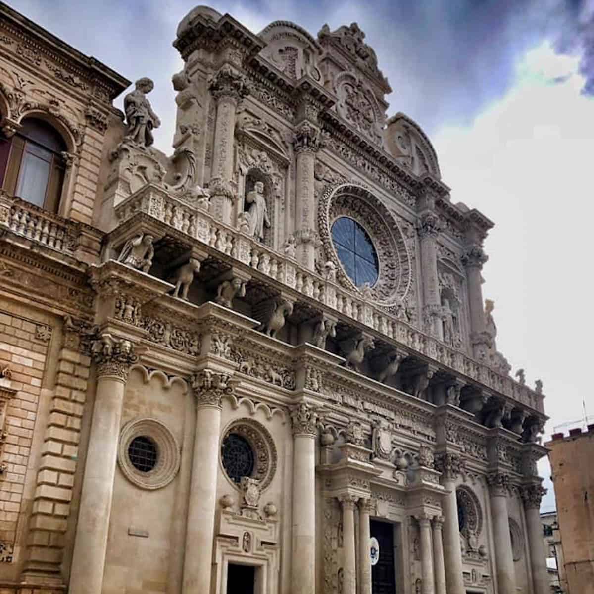 The intricately carved Baroque facade of Santa Croce Basilica in Lecce, Italy.