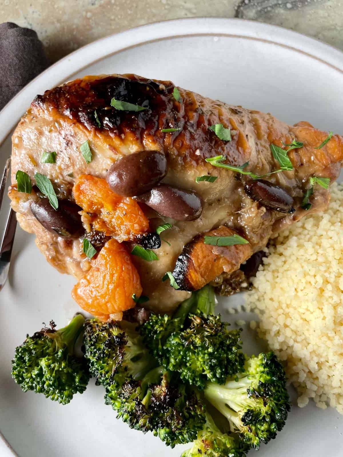 Chicken Marbella with apricots and olives served with quinoa and broccoli.