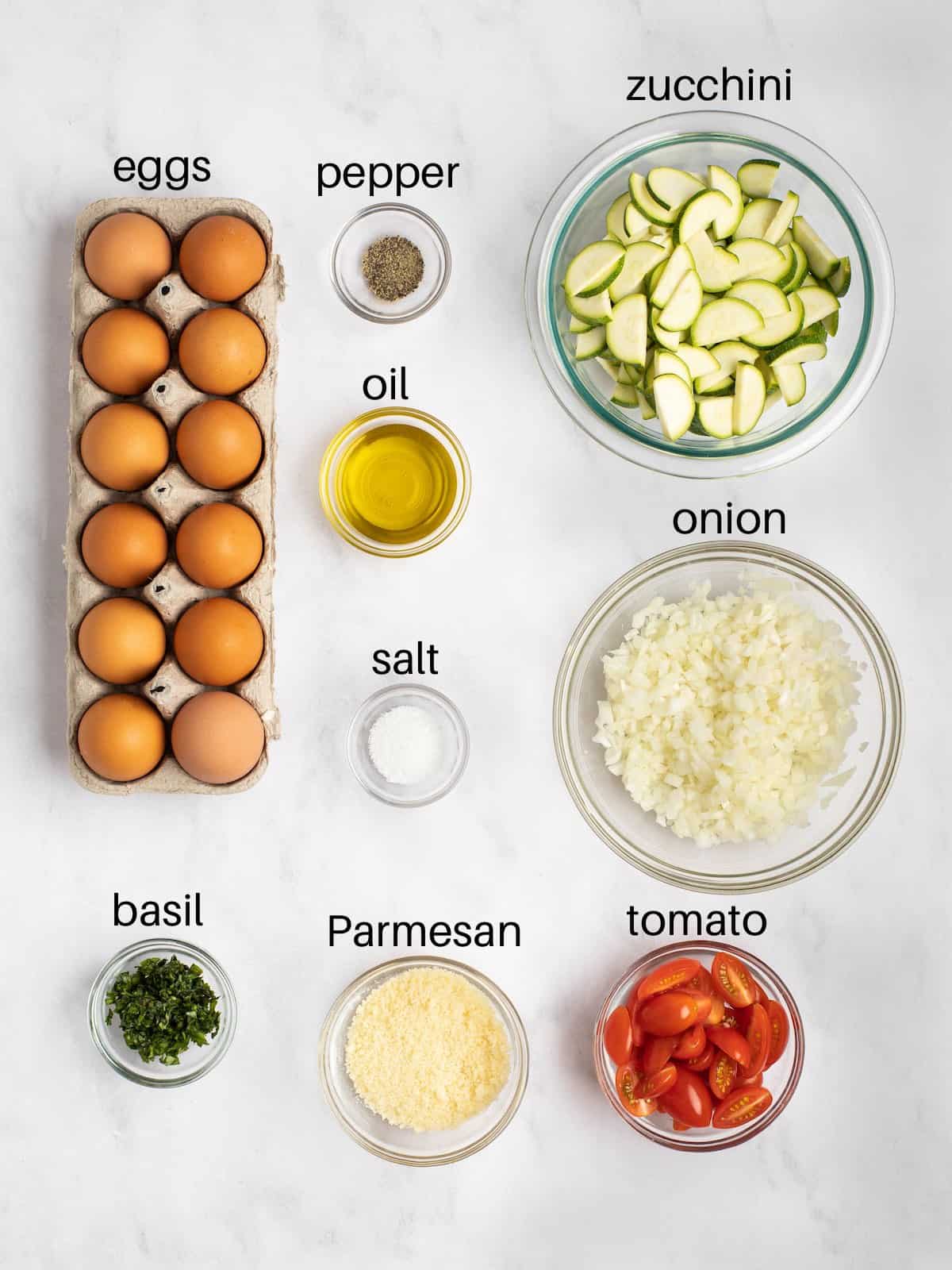 Ingredients needed to make baked Italian frittata with tomatoes and zucchini.