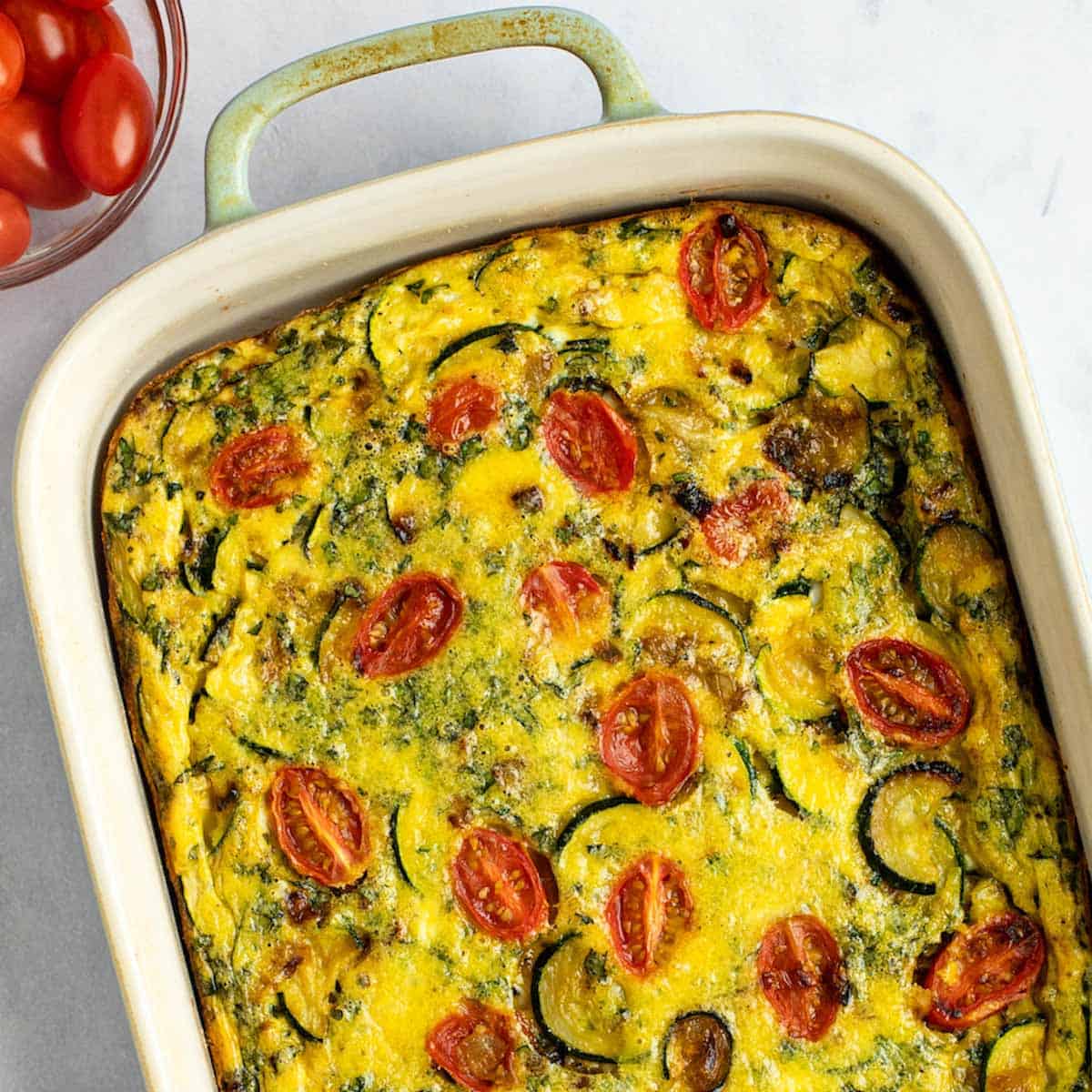Baked Italian frittata with zucchini and tomatoes.
