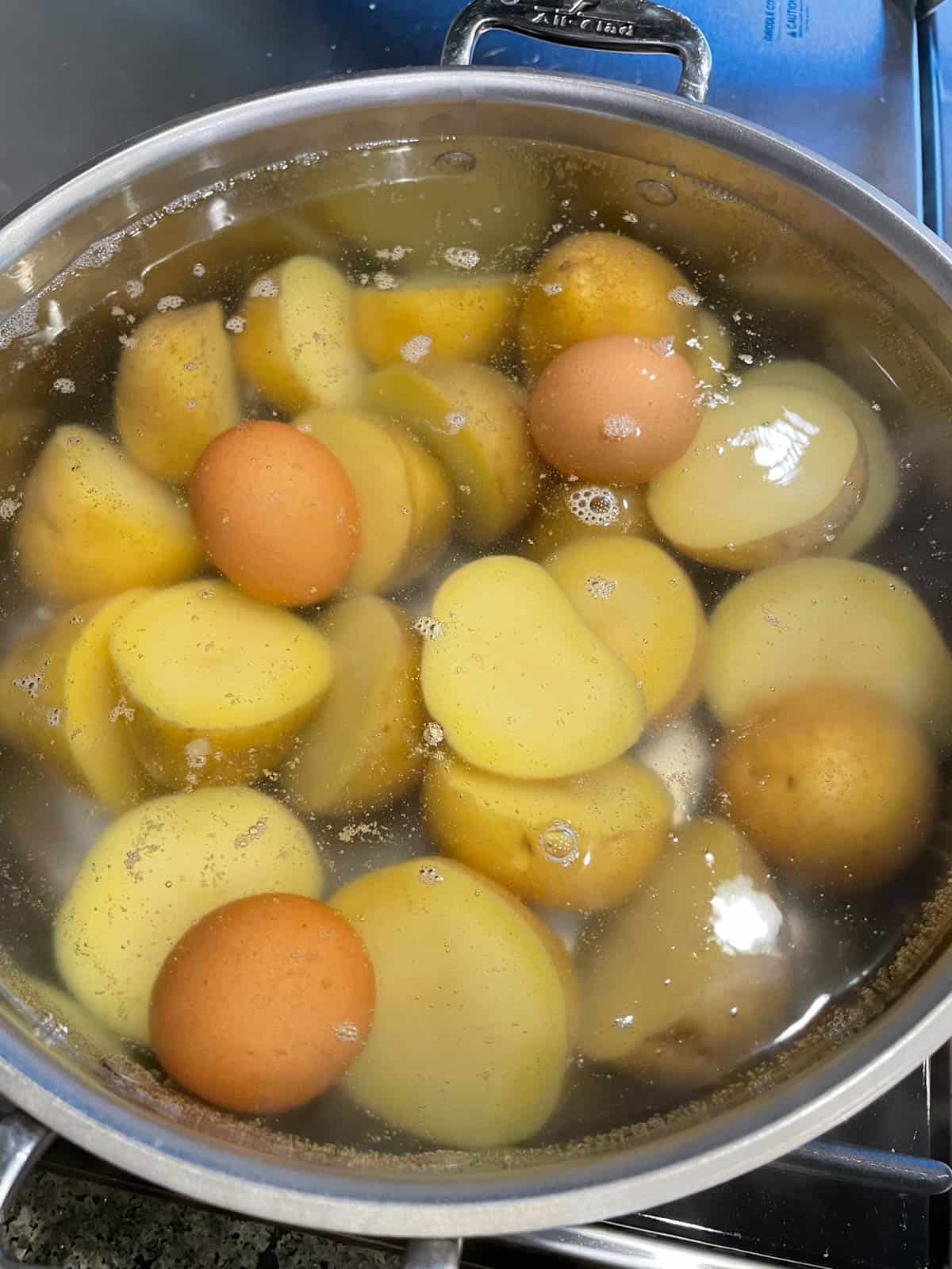 Potatoes boiling in a large pot. 