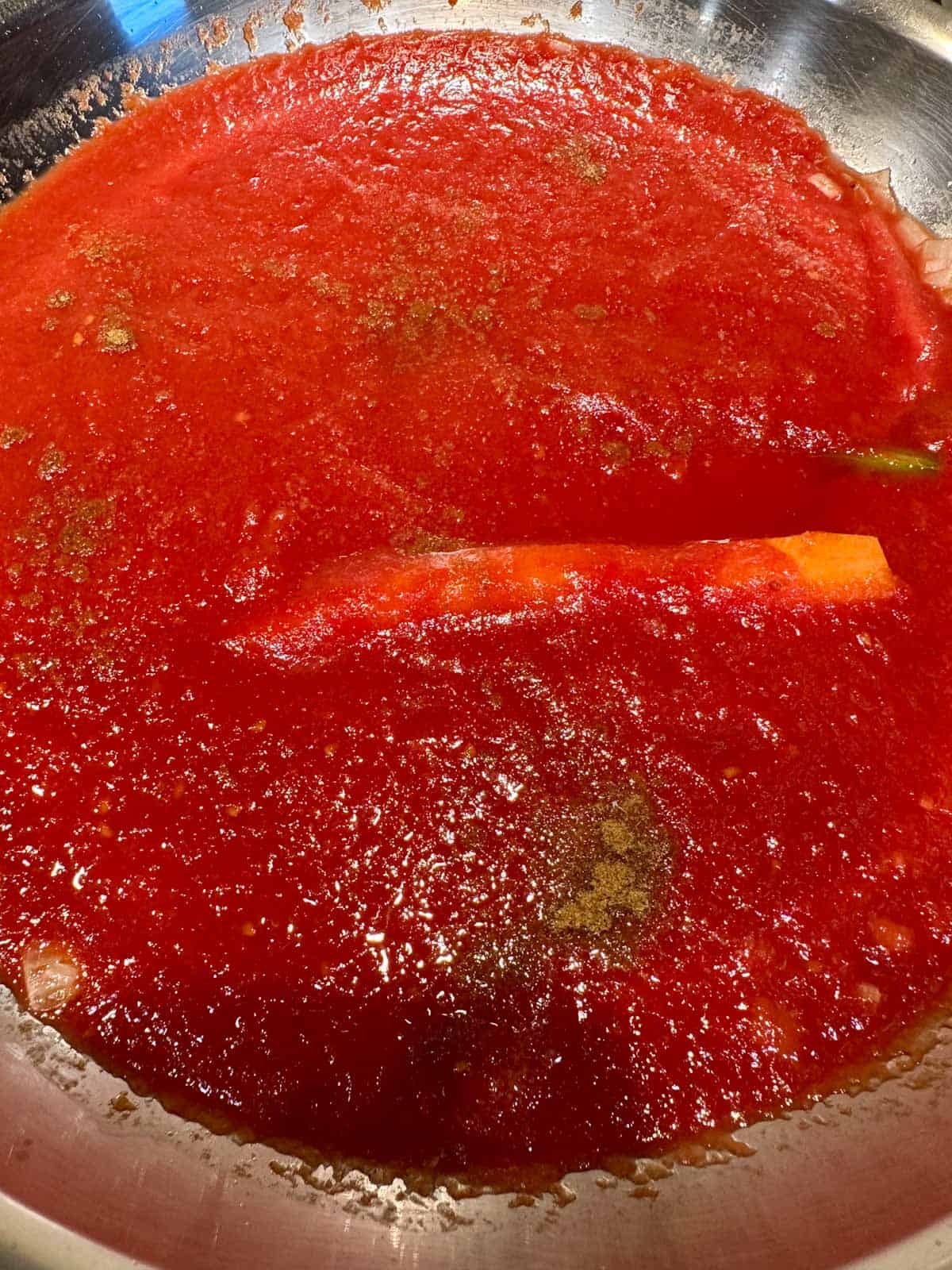 Tomato sauce cooking in a skillet.
