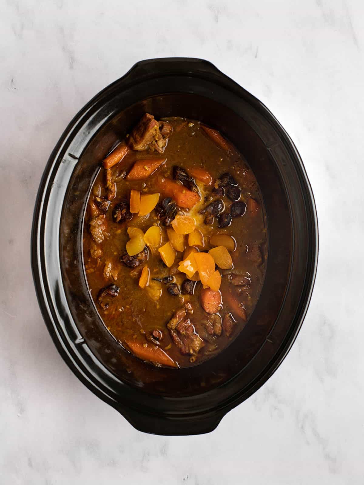 Lamb tagine in a slow cooker with apricots and dates.
