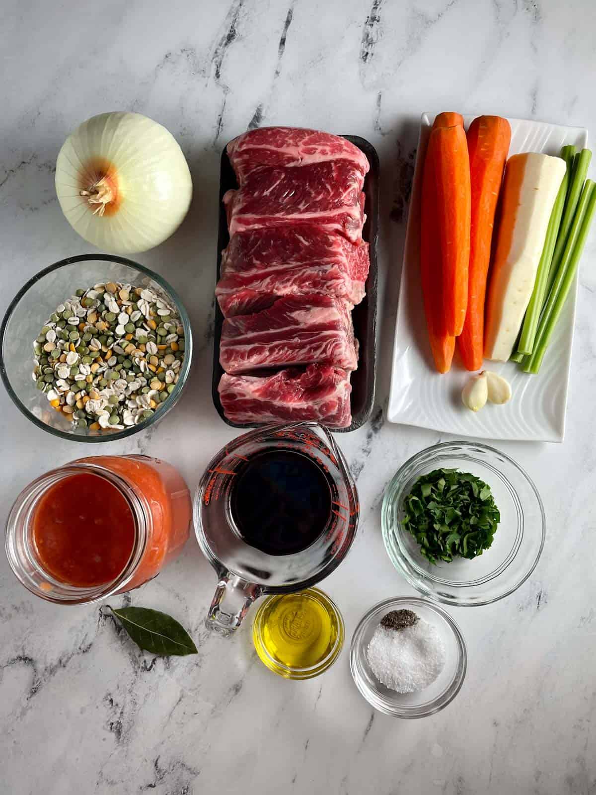 Ingredients needed to make beef and barley soup with vegetables.