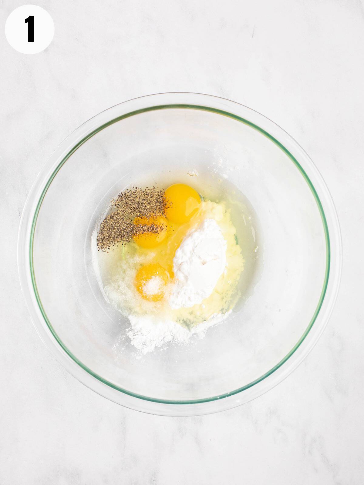 Eggs, seasonings, and potato starch in a mixing bowl.