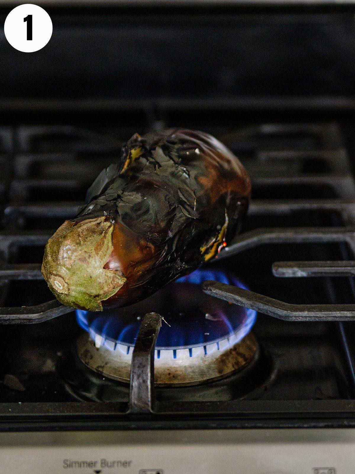 Blistering an eggplant on a gas stove.