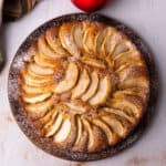 Apple cake with apple slices and powdered sugar.