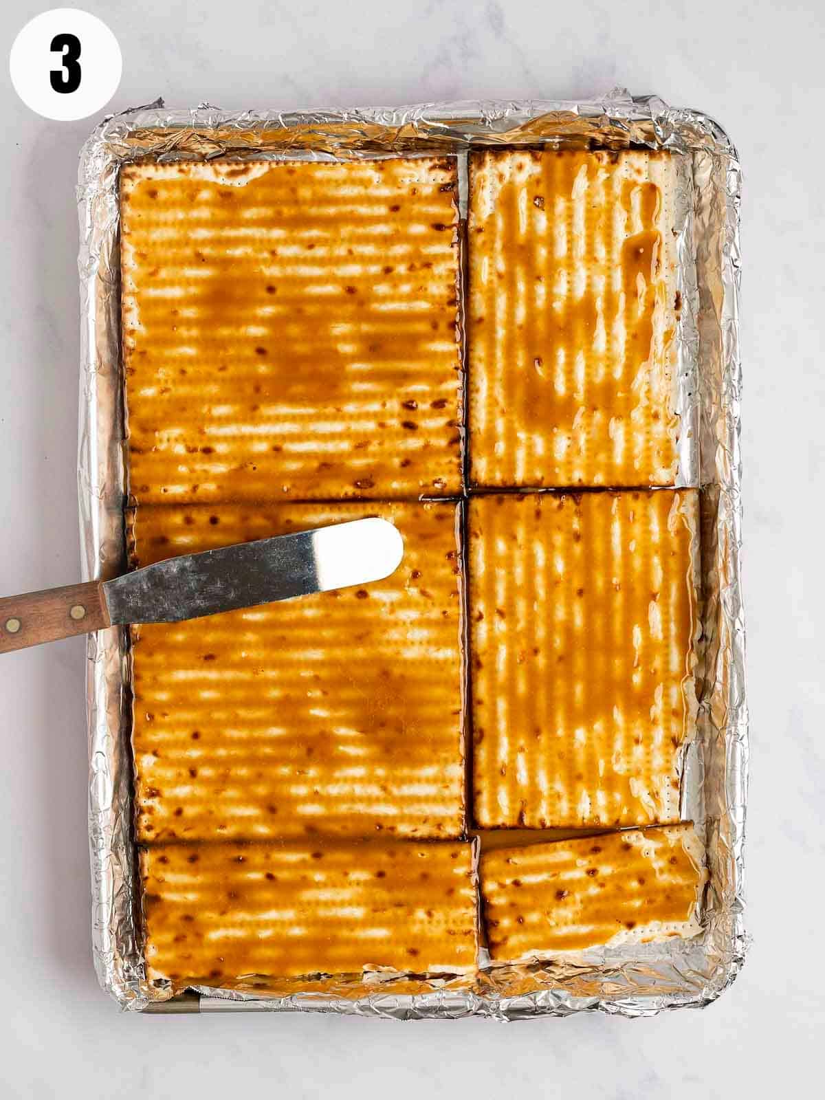 Spreading toffee on matzo crackers.