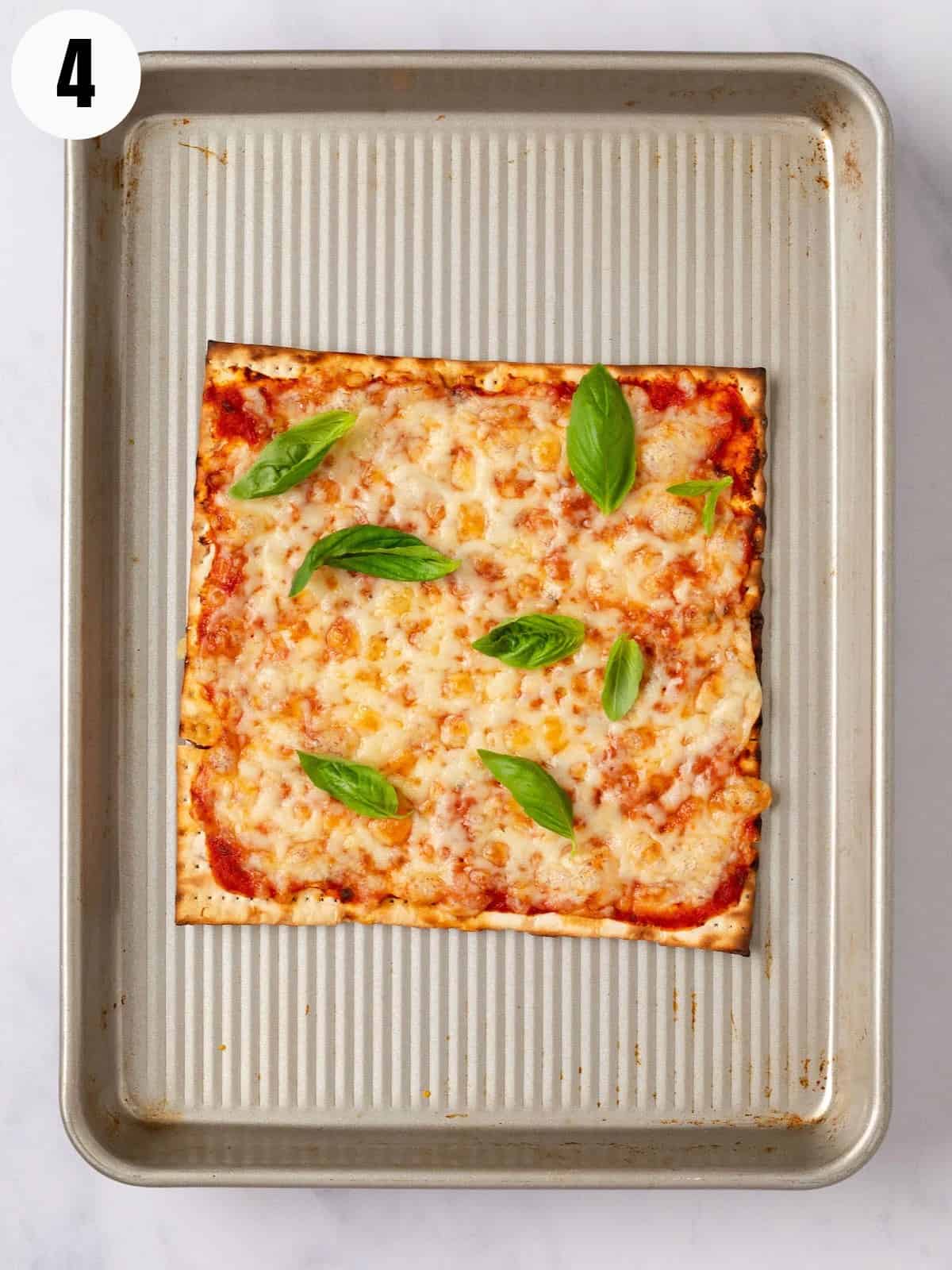 Matzo baked with sauce, mozzarella, and topped with fresh basil.