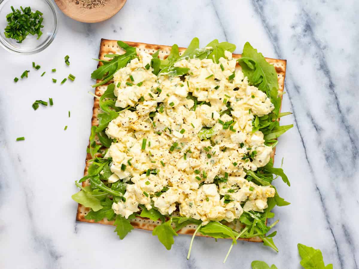 Egg salad with arugula on matzo.