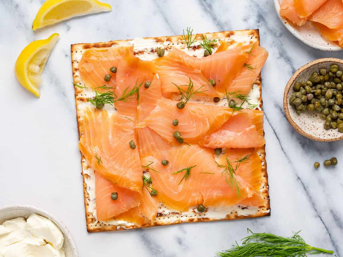 Matzo with cream cheese, lox, and capers.