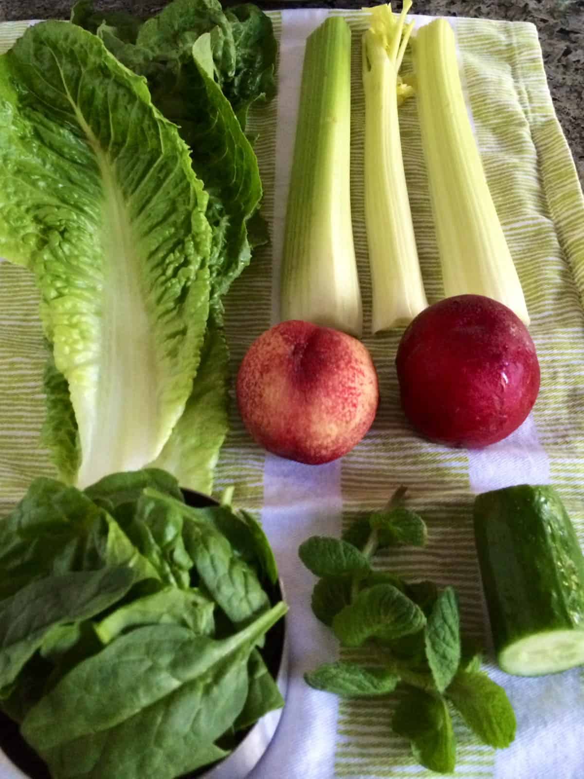 Ingredients for green juice drying on a kitchen towel.