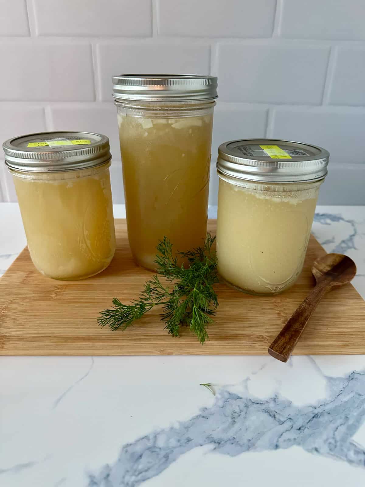 Three jars of homemade chicken bone broth.