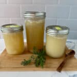 Three jars of homemade chicken broth.