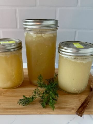 Three jars of homemade chicken broth.