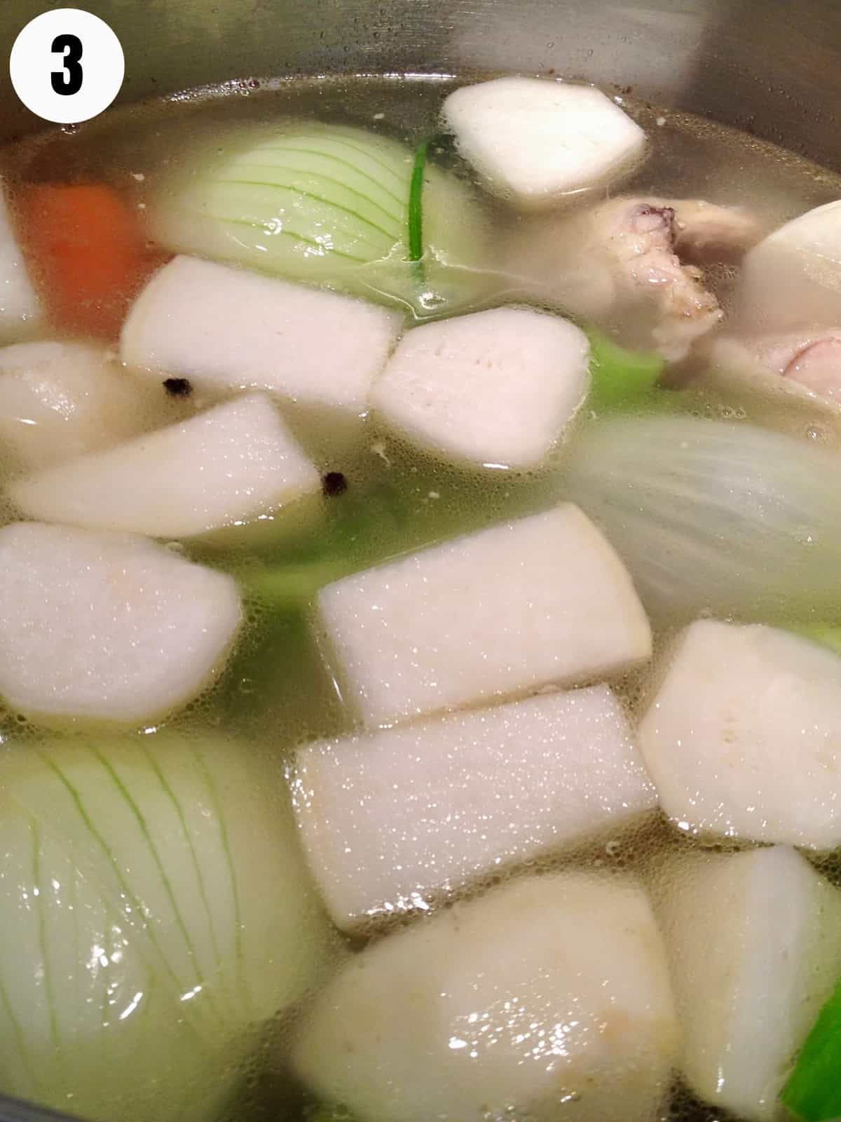 Simmering vegetables in bone broth.