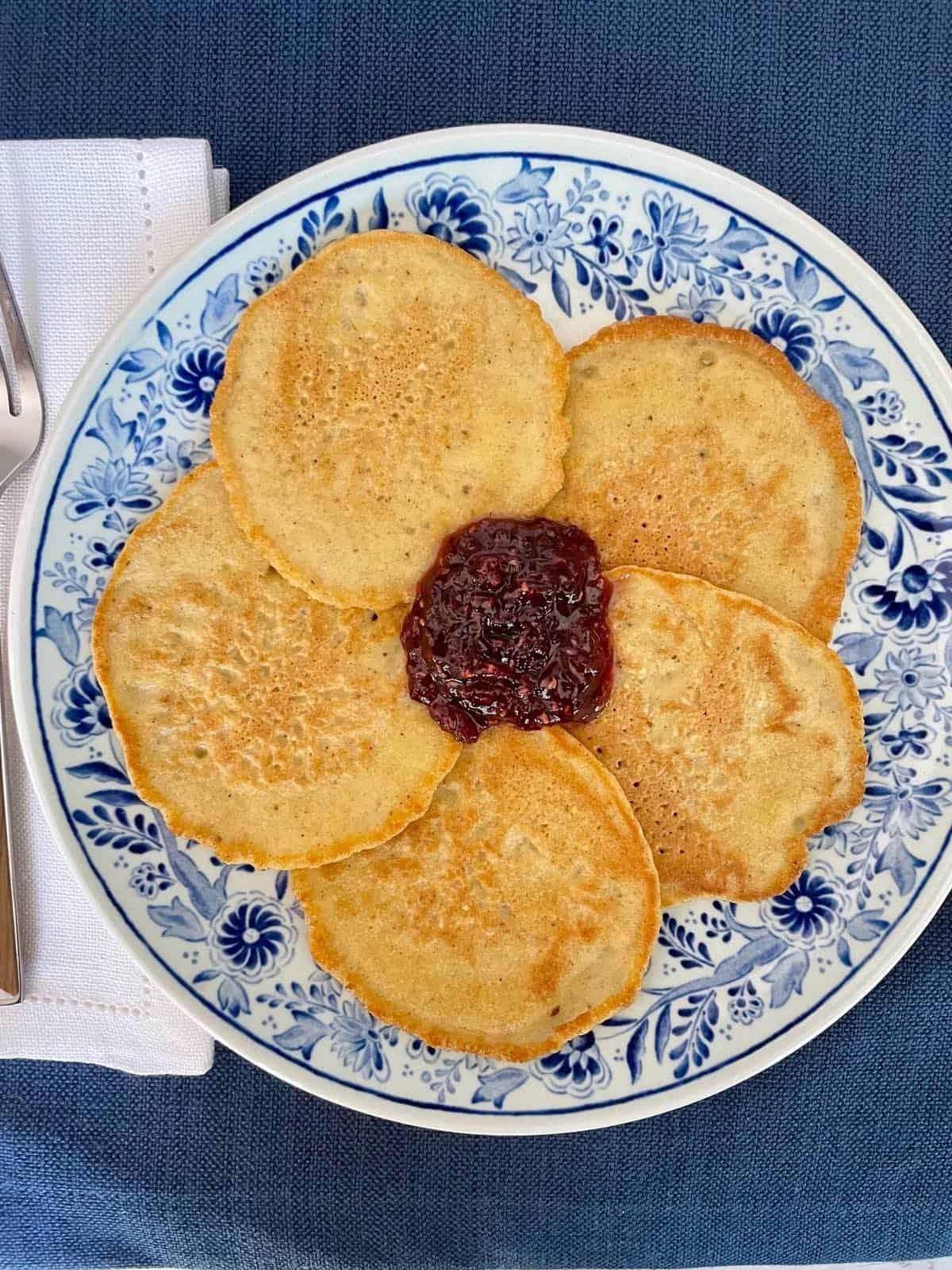 A plate with matzo meal pancakes and jam.