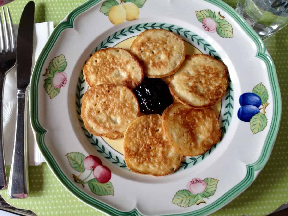 Matzo meal pancakes on a plate with jam.