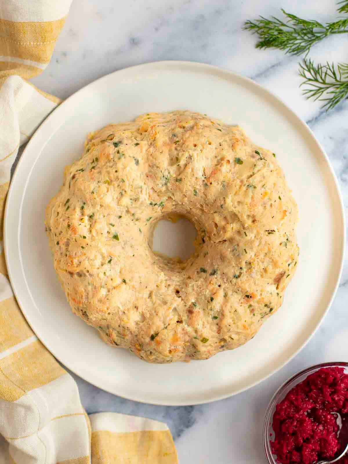 Gefilte fish on a platter with horseradish on the side. 