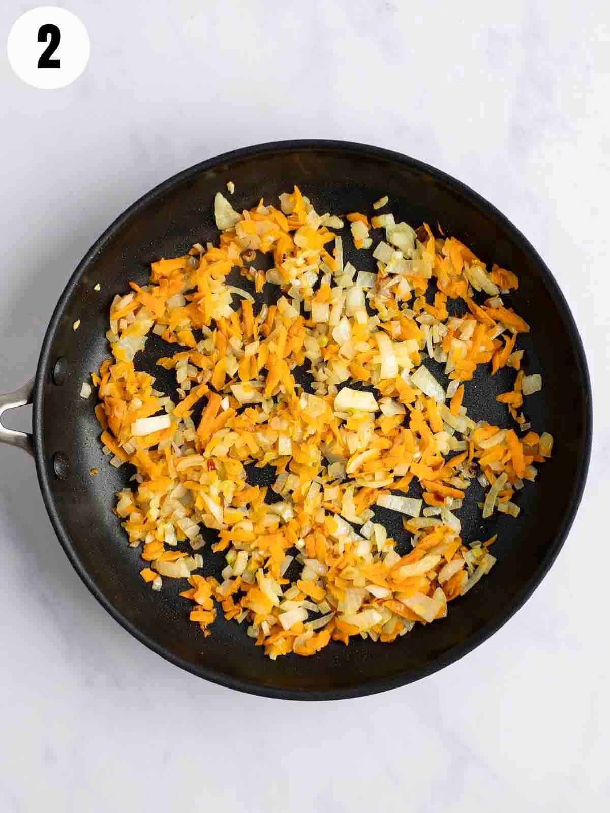 Cooking carrots and onions. 