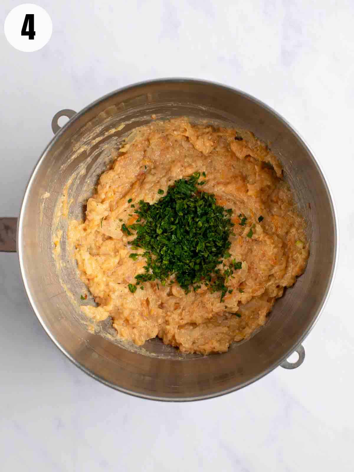 Blending the ingredients for gefilte fish with parsley.