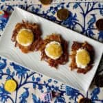 Potato latkes topped with sour cream and applesauce.
