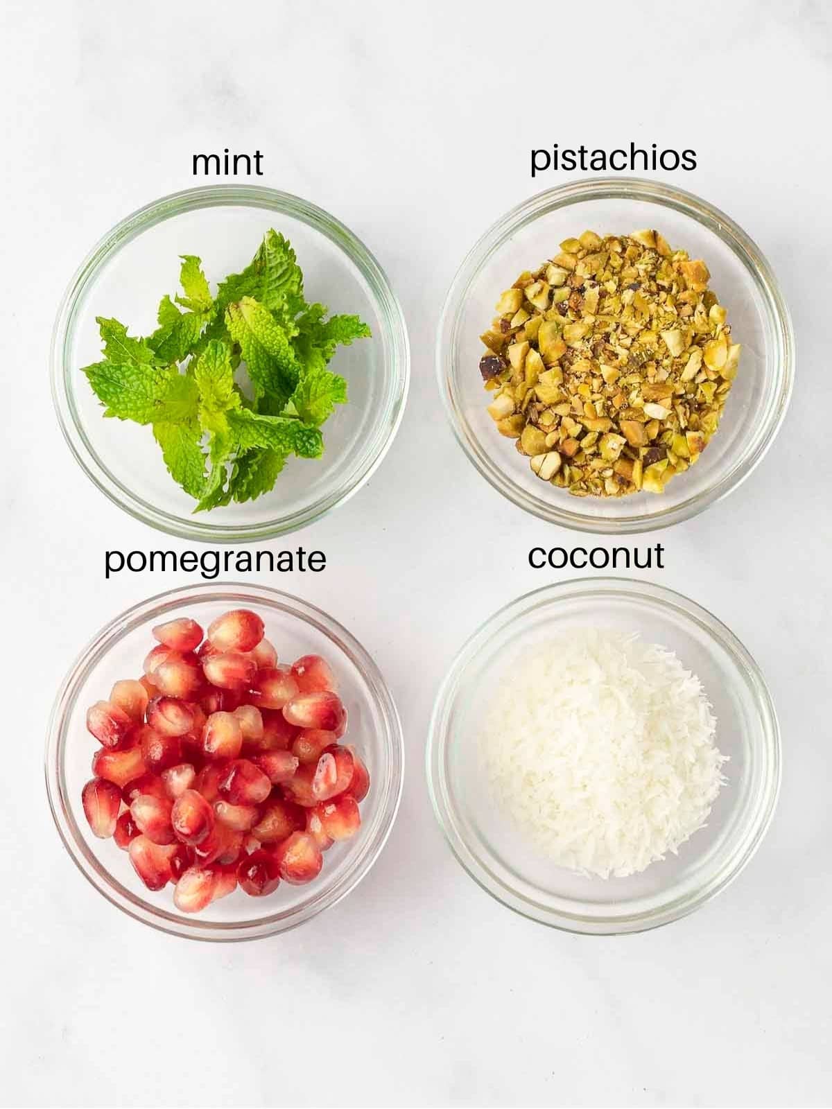 Malabi garnish ingredients; mint, pomegranate, pistachios and coconut.