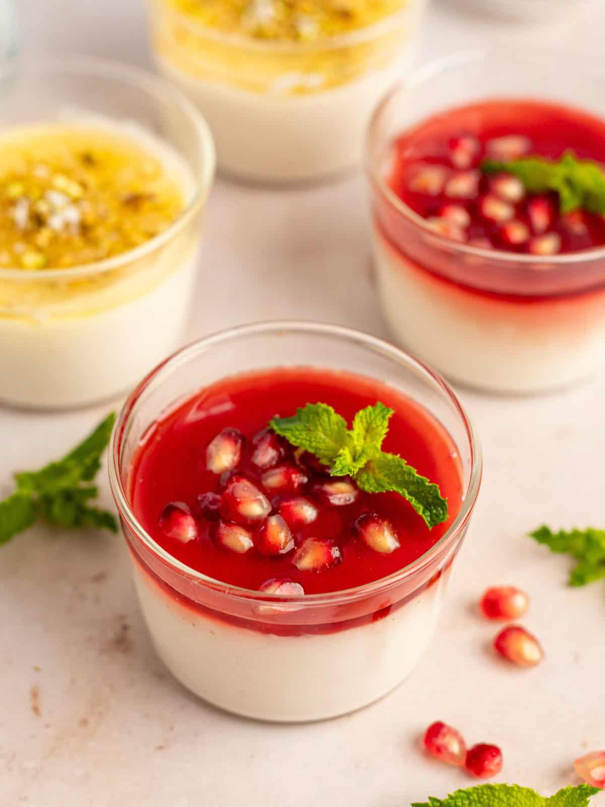 Malabi pudding bowls with topping variations in raspberry and peach.  