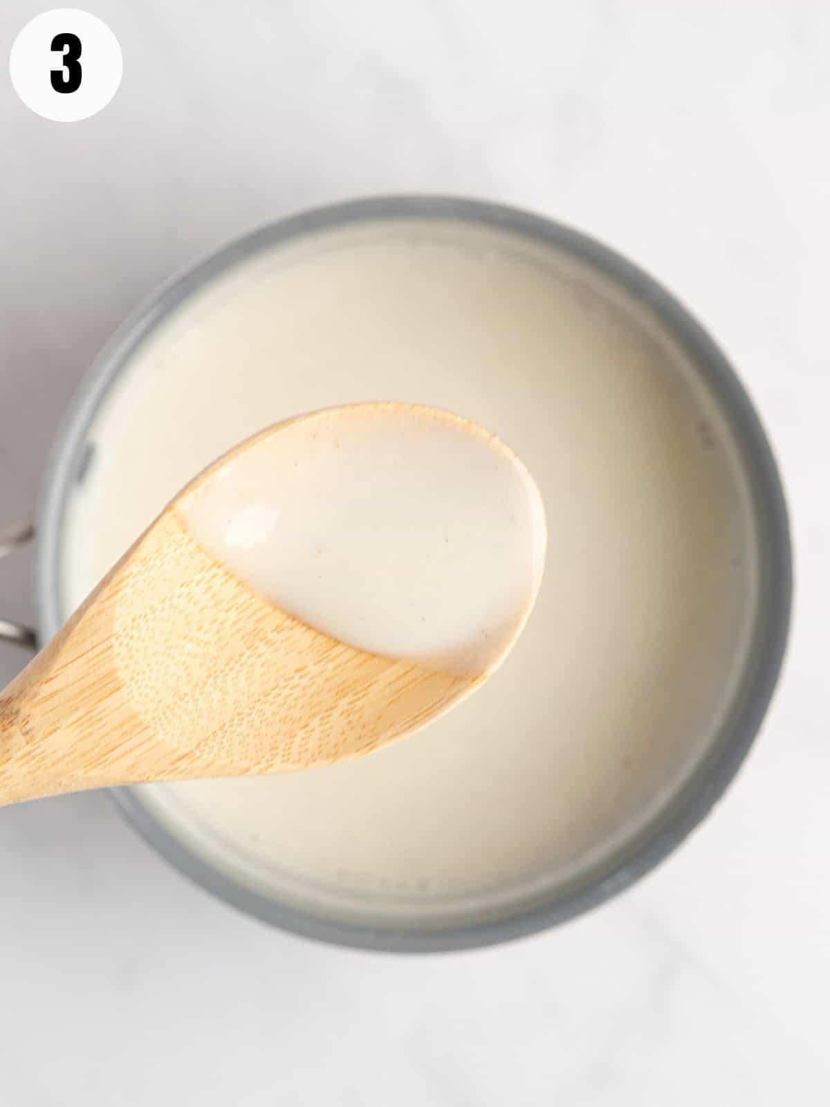 Thickening of the pudding in the pot with a wooden spoon.