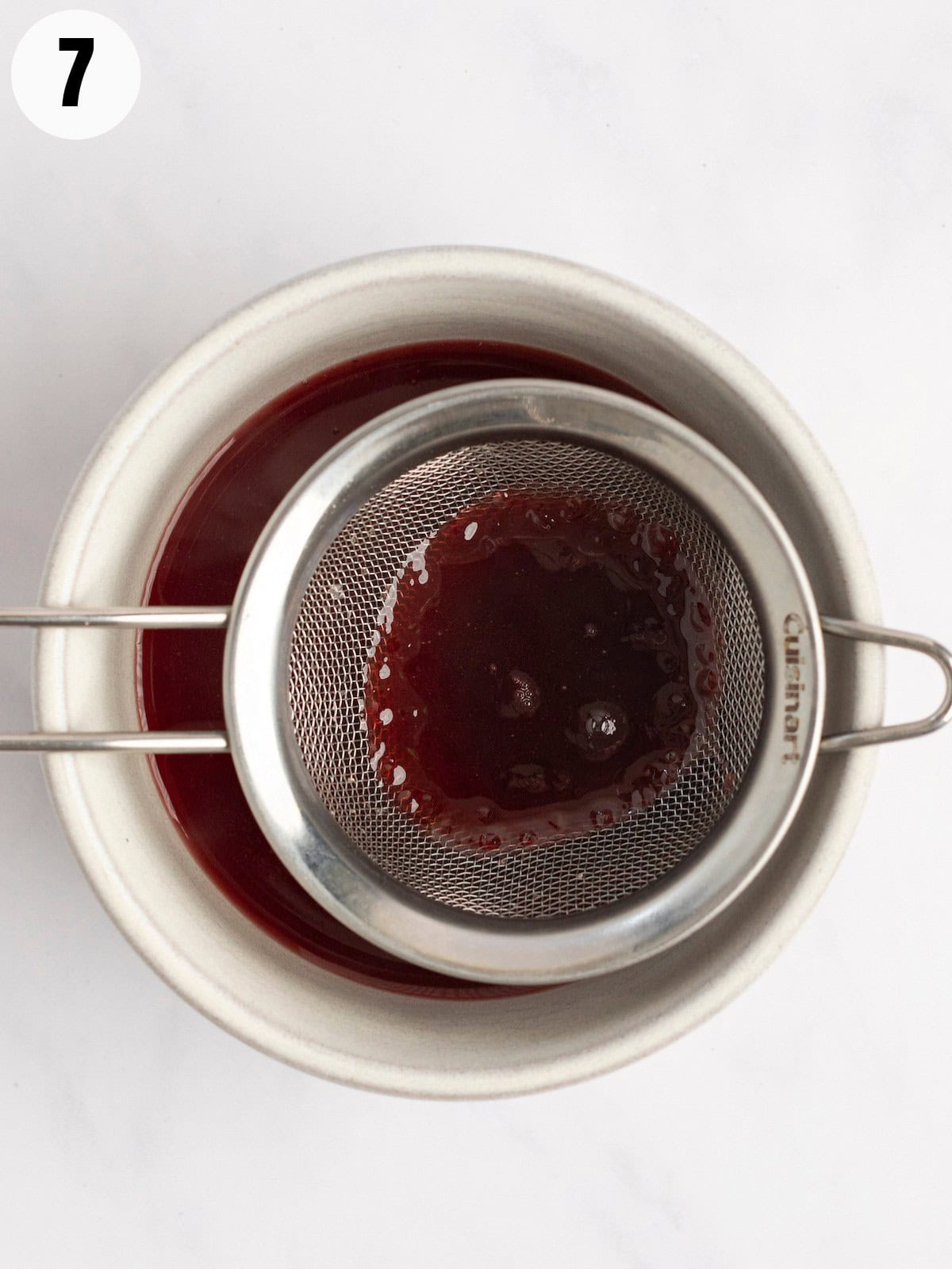Straining the syrup over a bowl.