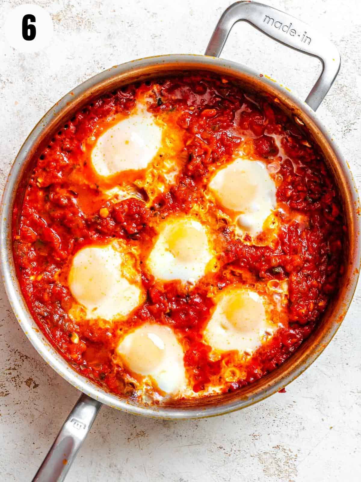 Cooked eggs in tomato sauce.