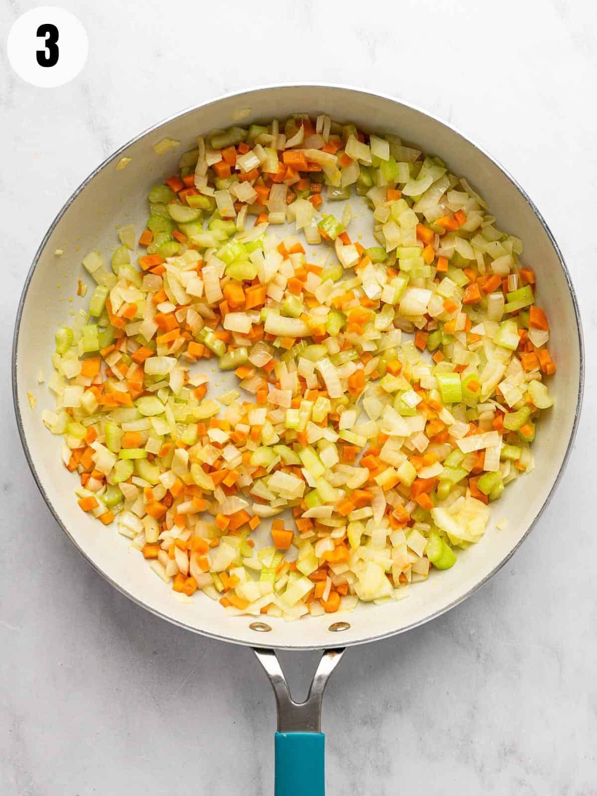 Sauteing the vegetables in a skillet.