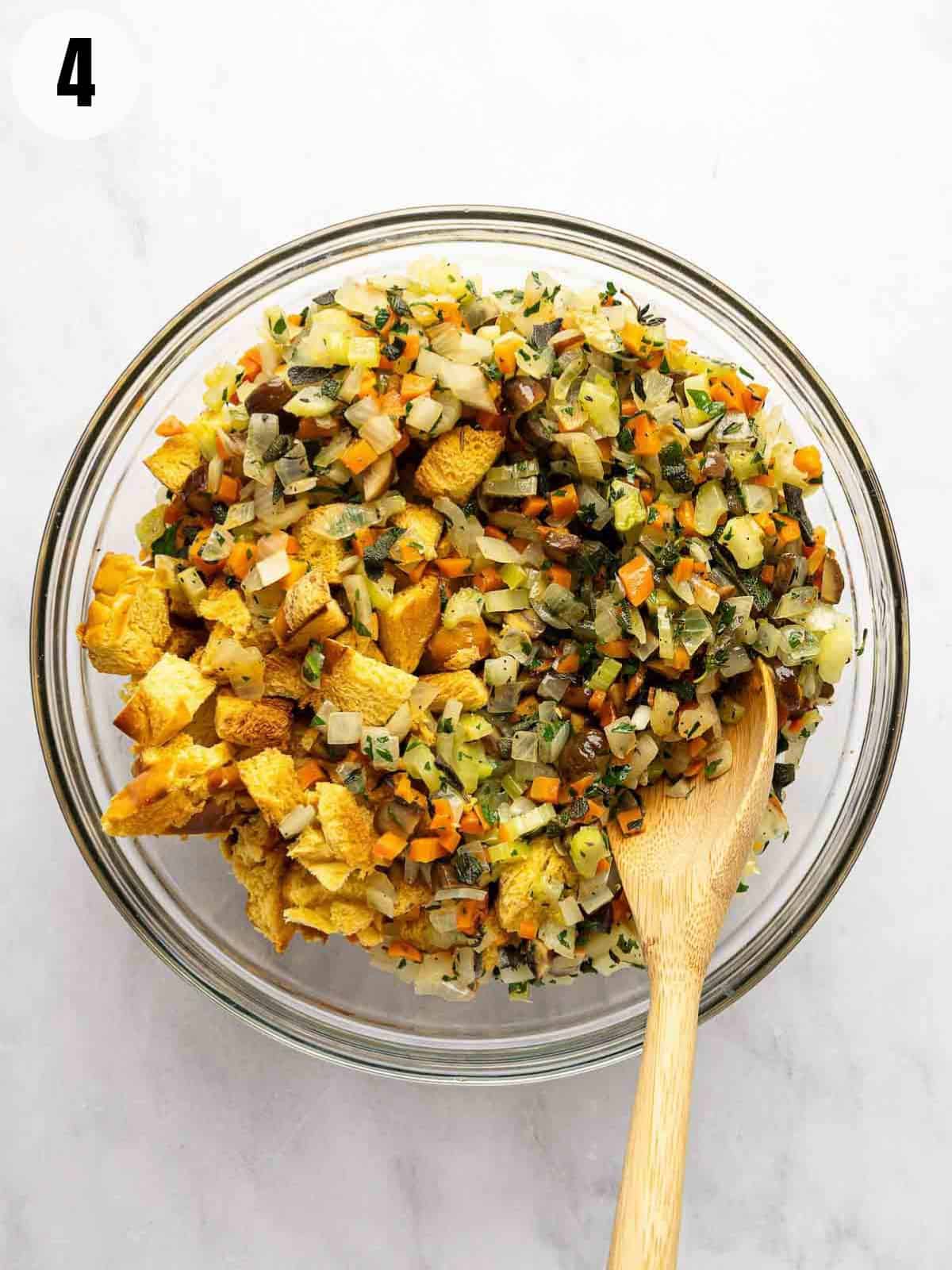 Mixing the vegetables with the cubed challah.