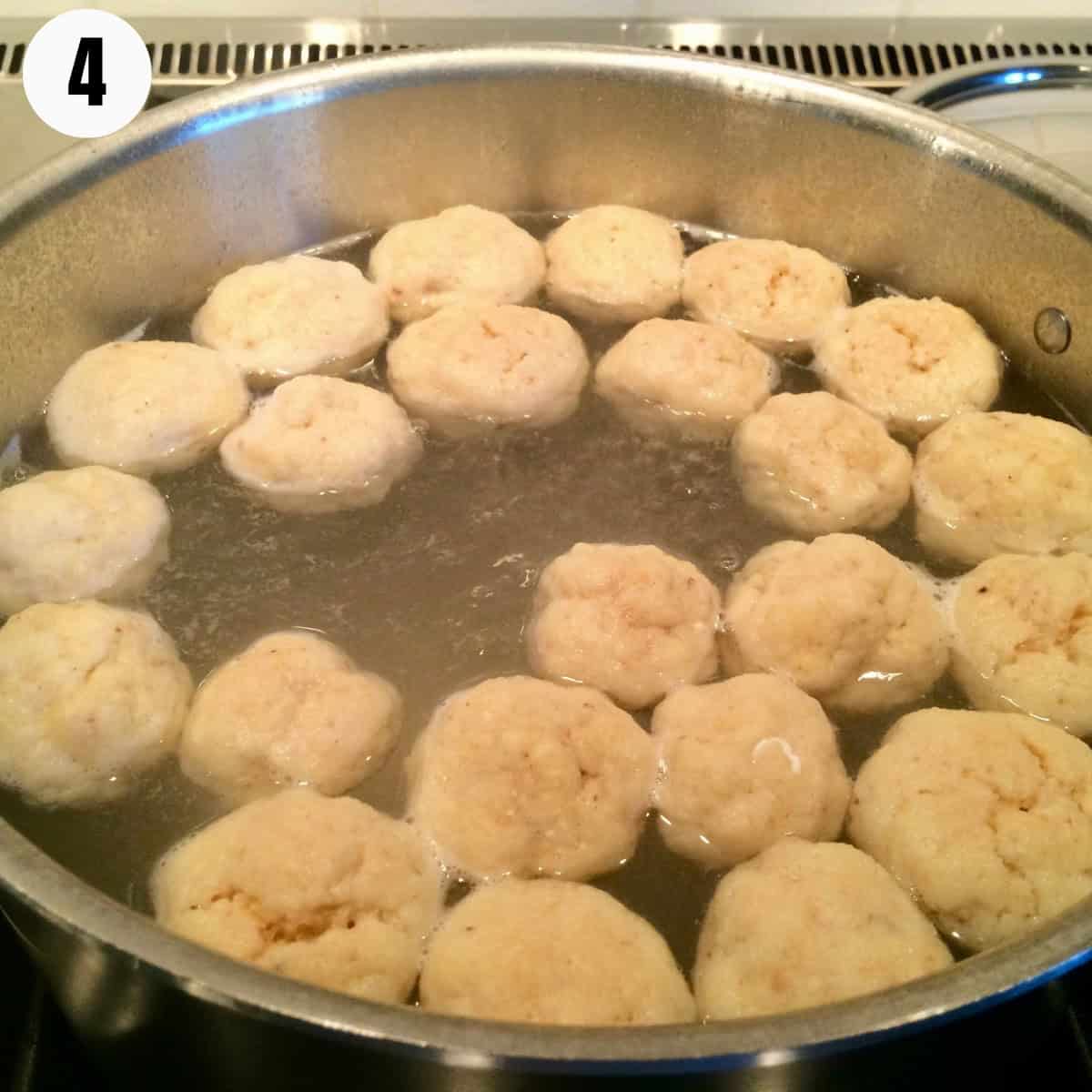 What cooked matzo balls look like when they are done cooking in the pot.